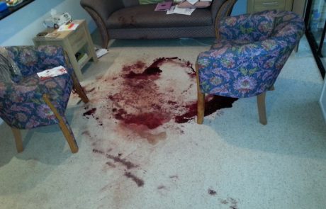 Crime Sceners with Blood on the Floor in a living room